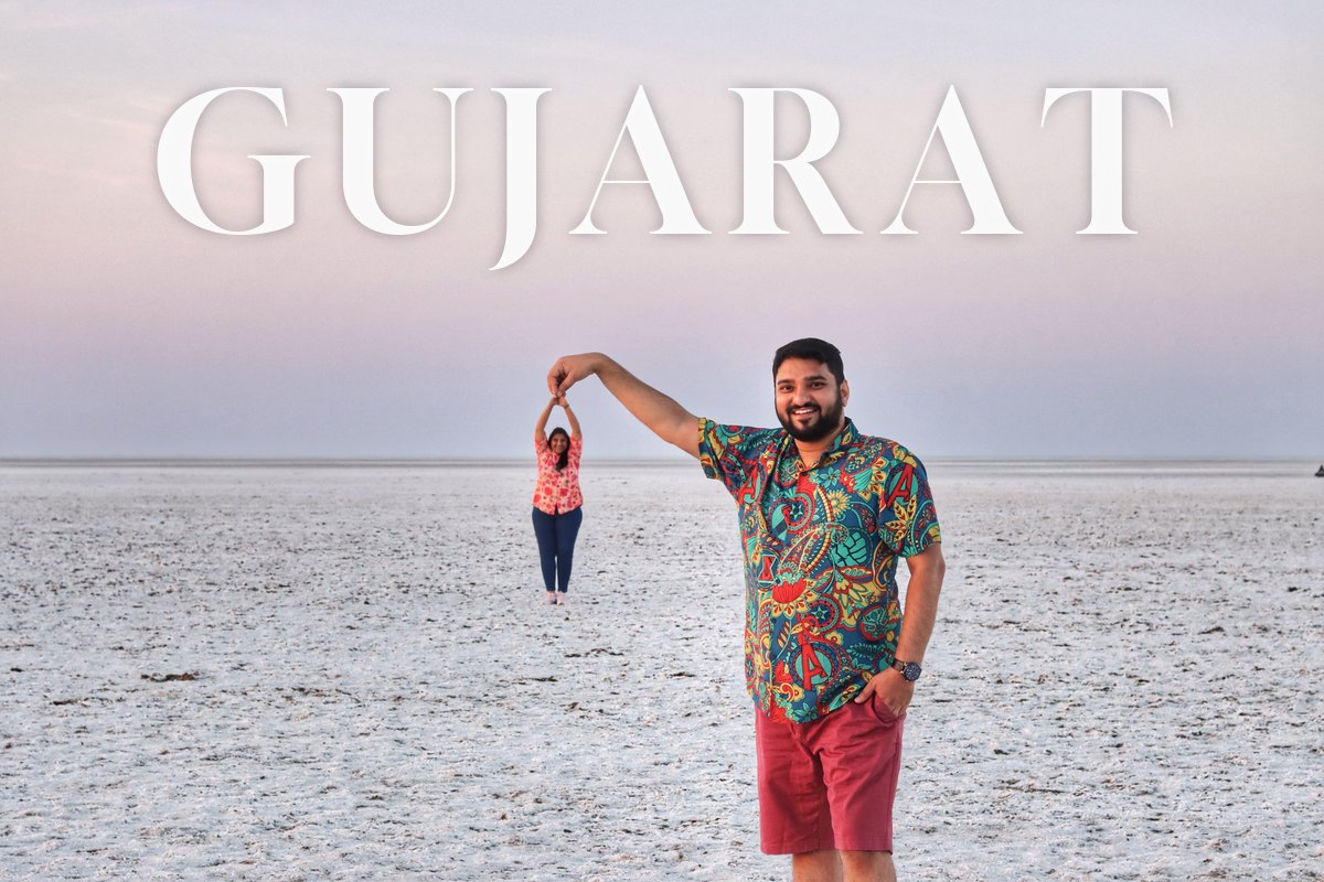 GUJARAT written across a pastel sky over the White Rann, Shriram holding Saudamini up by her hands in a perspective trick
