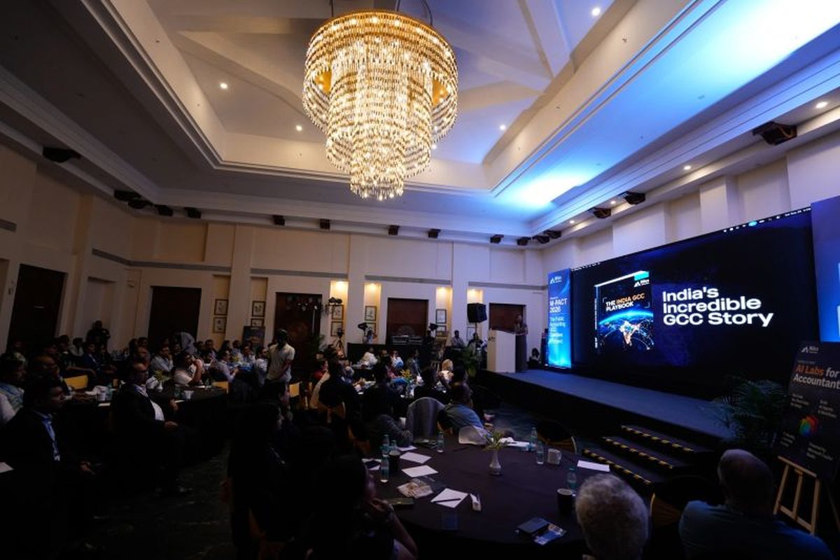 The M-Pact 2026 hall in Goa under a chandelier, the India GCC Playbook on the big screen