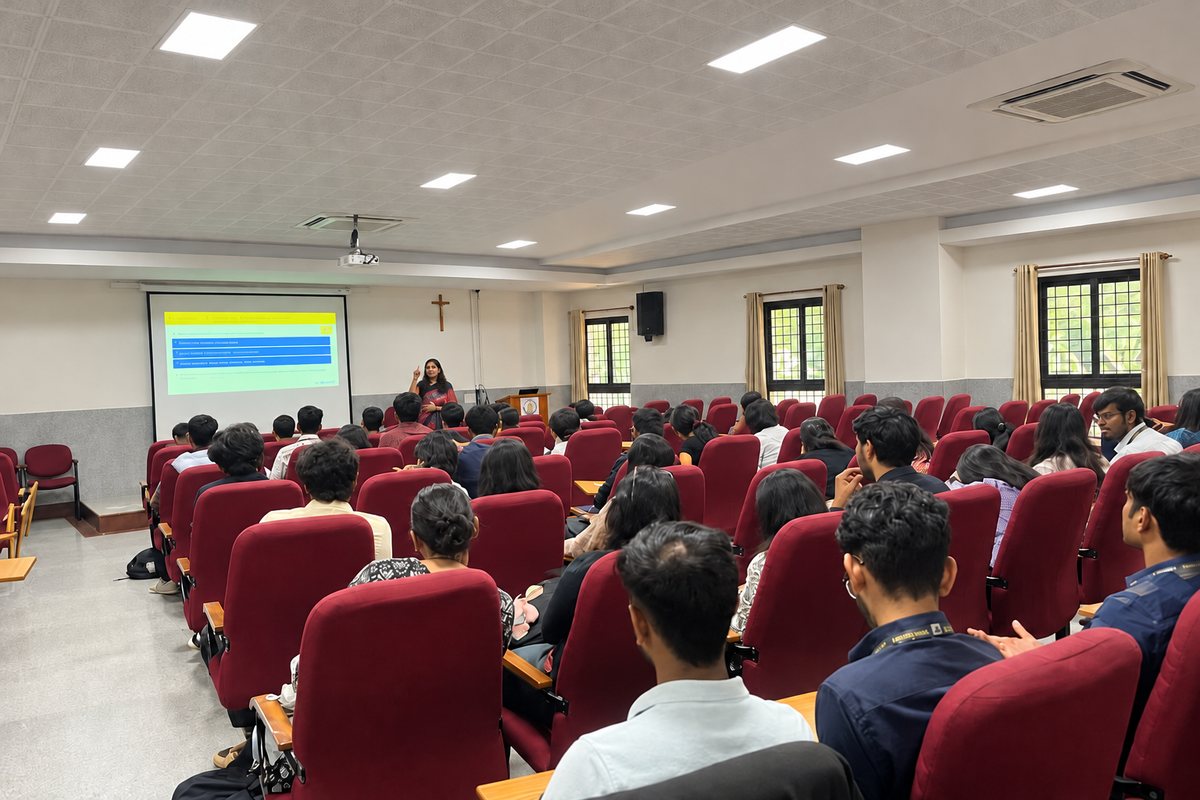 Saudamini presenting to a full lecture hall of students