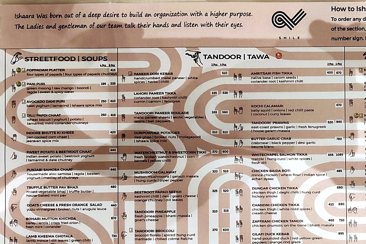 The Ishaara menu: a note about a team who talk with their hands, and a hand sign beside every dish