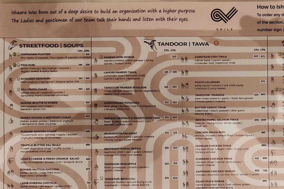 The Ishaara menu: a note about a team who talk with their hands, and a hand sign beside every dish