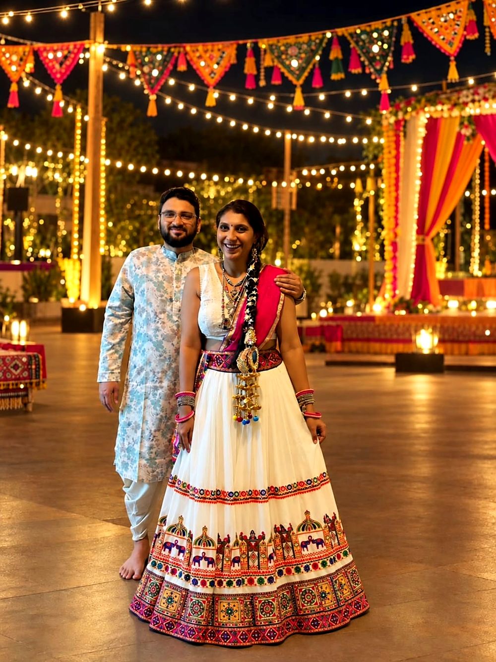 Saudamini and Shriram at the garba ground under strings of lights