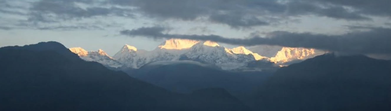 Khangchendzonga at first light, a faint gold touching the peaks