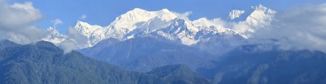 Khangchendzonga in brilliant white against a blue sky