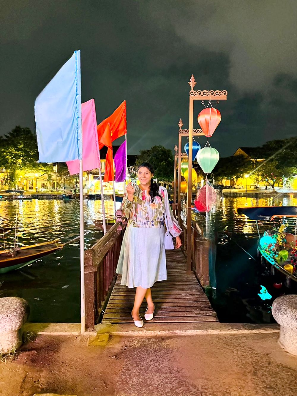 On a lantern-lit riverside walkway in Hoi An at night